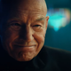 Patrick Stewart's Jean-Luc Picard smiles as he reunites with Guinan in a scene from Star Trek: Picard season 2.
